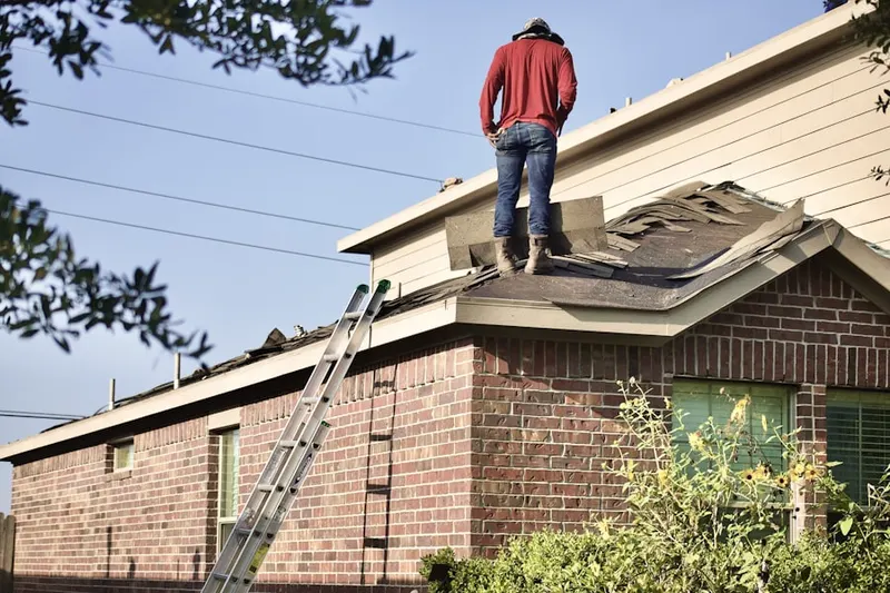 Professional roofer working on a residential roof in Mad River